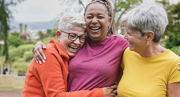 Group of senior women laughing representing hormone testing for menopause 